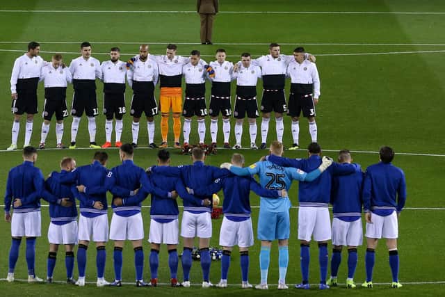 Sheffield United and Wednesday players line up for a minute's silence ahead of a derby game: James Wilson/Sportimage