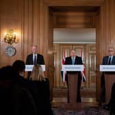 Chief Medical Officer Chris Whitty (L) and Chief Scientific Adviser Patrick Vallance (R) look on as Britain's Prime Minister Boris Johnson addresses media (Photo by LEON NEAL/POOL/AFP via Getty Images)