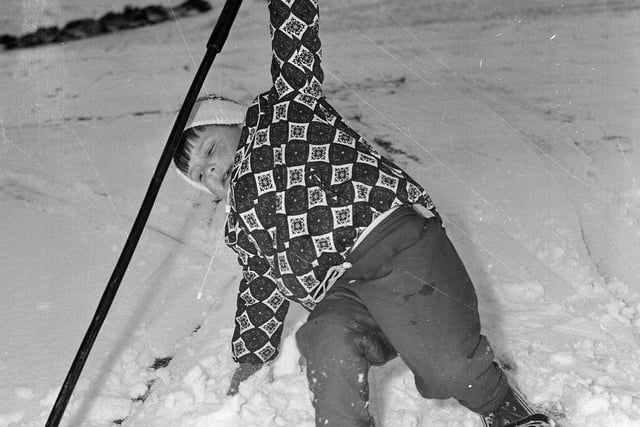 A youngster takes a dive at a snowy Hillend in December 1964.
