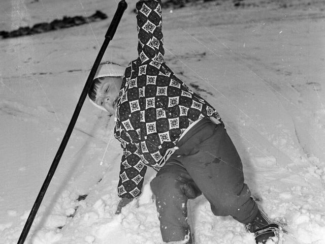 A youngster takes a dive at a snowy Hillend in December 1964.