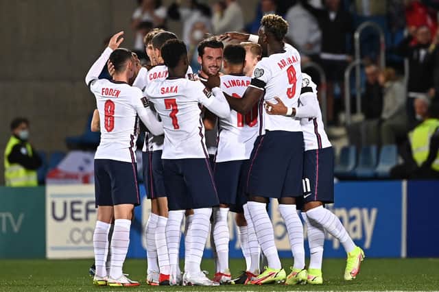 England's defender Ben Chilwell (C) is congratulated by teammates after scoring a goal during the World Cup 2022 qualifier football match between Andorra and England at Estadi Nacional stadium in Andorra la Vella, on October 9, 2021. (Photo by LIONEL BONAVENTURE/AFP via Getty Images)