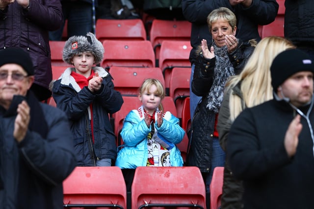 United supporters take part in a minute's applause in memory of former goalkeeper Alan Hodgkinson and official club photographer Martyn Harrison before the game with Coventry City in December 2015.