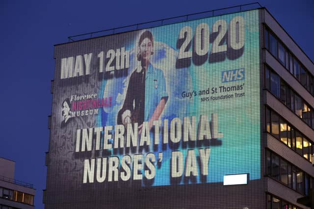 An image of trailblazing nurse Florence Nightingale is projected on to St Thomas' Hospital in central London to commemorate the 200th anniversary of her birth on May 12, 1820