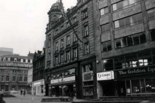 Businesses on Fargate, in Sheffield city centre, including Joan Barrie ladies fashions, Burnley Building Society, La Coupe unisex hairdressers, and The Golden Egg restaurant.
