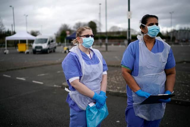 NHS nurses speak to the media as they wait for the next patient at a drive through Coronavirus testing site (Photo by Christopher Furlong/Getty Images)