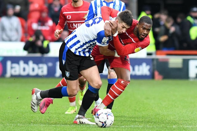 Picture: Andrew Roe/AHPIX LTD, Football, Sky Bet League One, Doncaster Rovers v Sheffield Wednesday, Eco Power Stadium, Doncaster, UK, 19/02/22, K.O 3pm
Howard Roe>>>>>>07973739229, 

Doncaster's Reo Griffiths battles with Wednesday's Jordan Storey