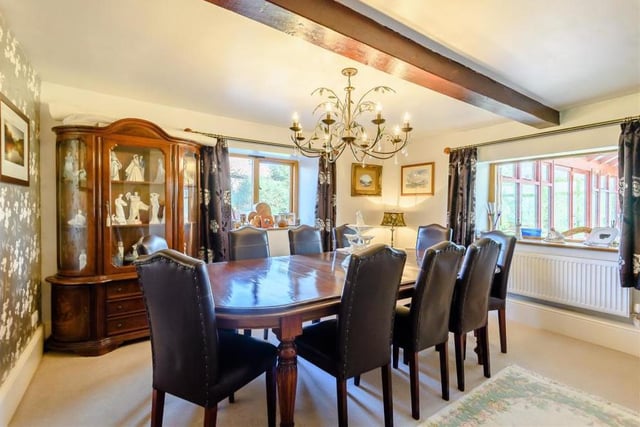 The dining room oozes class and elegance. It boasts a fine fireplace with an inset multi-fuel stove, stone hearth and mantle above, plus a central beamed ceiling and double-glazed windows to the side and rear.