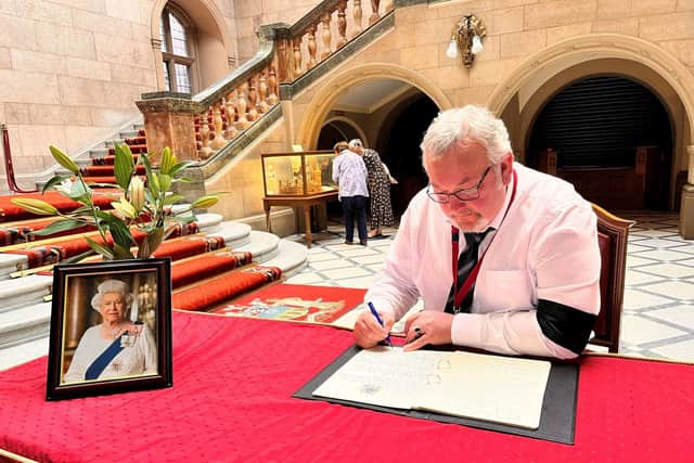 Councillor Terry Fox, leader of Sheffield Council, writing in the book of condolence in the Town Hall following the death of Queen Elizabeth II.