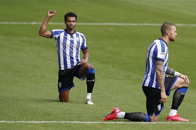 Jacob Murphy holds up his fist as Sheffield Wednesday players take a knee. (Martin Rickett/PA Wire)