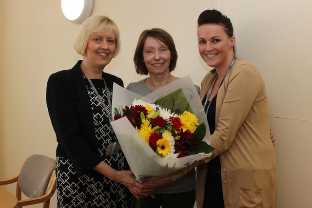 Pauline Gibbon (centre) retired as a dinner lady from Littlemoor Children's Centre and Infant School after 29 years, she is pictured in 2014 receiving flowers from the headteacher Carol Ann Turner (l) and Amy Patrick, who was a pupil at the school when Pauline was started as a dinner lady