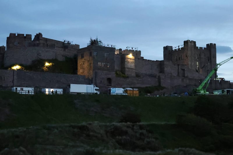 Bamburgh Castle lit up for night-time filming.