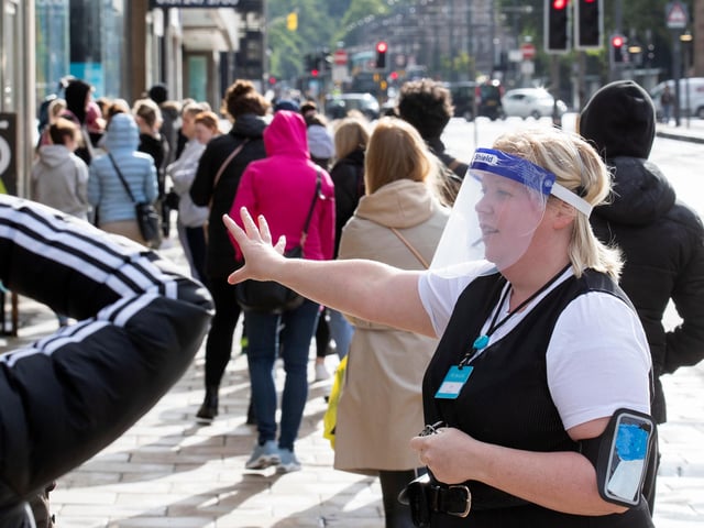 Members of staff at Primark on Princes Street in Edinburgh, welcome customers after the store reopened today as part of Scotland's phased plan to ease out of the coronavirus pandemic lockdown.