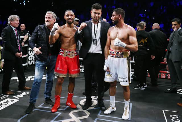 Kell Brook (second left) celebrates victory over Amir Khan (right) during their Welterweight contest  at AO Arena on February 19, 2022 in Manchester, England. (Photo by Nigel Roddis/Getty Images)