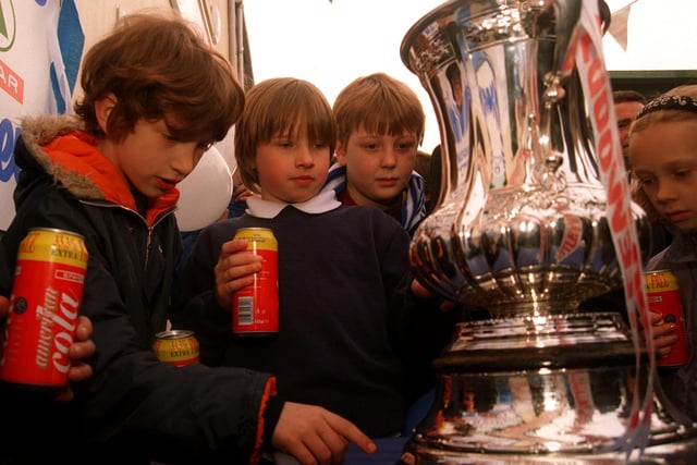 Chesterfield youngsters get a glimpse of the famous names engraved on the FA Cup as it visits the town prior to the FA Cup semi-final at Old Trafford