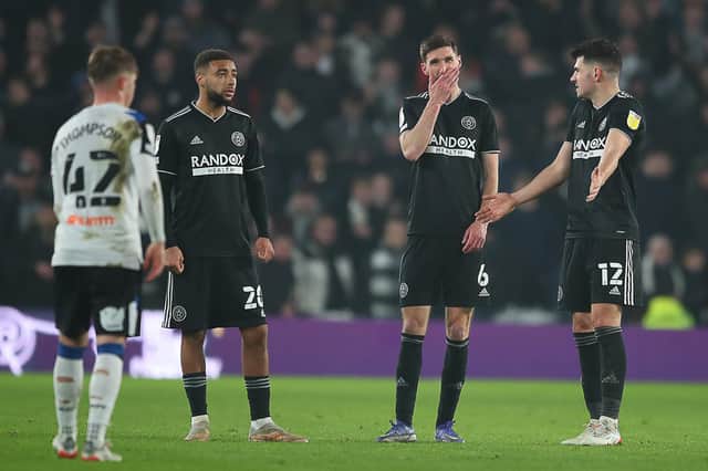 Jayden Bogle, Chris Basham and John Egan of Sheffield United look dejected after Derby's second goal: Simon Bellis / Sportimage