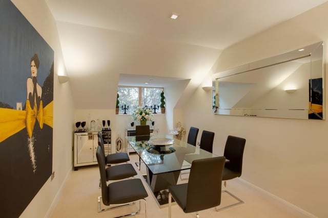 The formal dining room has space for a full-sized dining table and features a side-facing double-glazed window, recessed lighting, wall mounted light points, an extractor fan and under-floor heating.