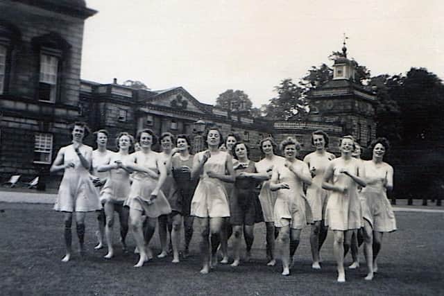 Lady Mabel College students practise a dance routine on the East Front lawns, in of the North Tower
