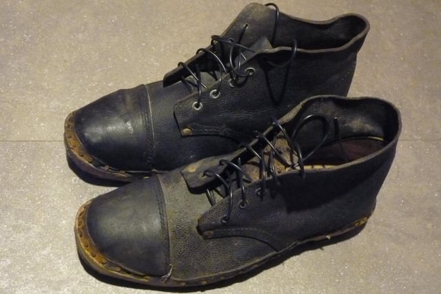 A pair of steel toe cap boots found under some rubbish in a locker room. 
There is no wear at all on the soles and the wooden section suggests these are very old clogs