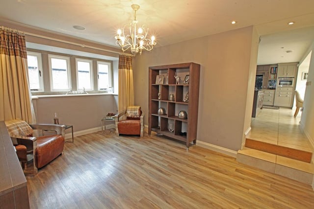 The sitting room provides access to the kitchen and a study which has a built in desk and cupboards.