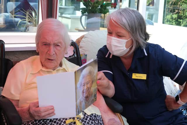 Kitty Little reads her 105th birthday card from the Queen