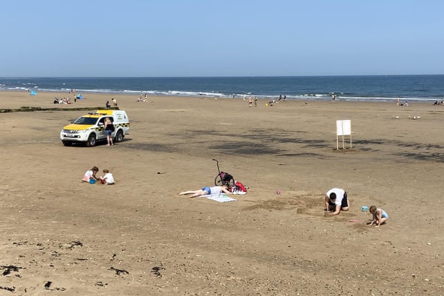The coastguard were on patrol as families played in the sand.