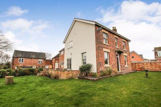This five bedroom house has outbuildings, garages and a outdoor heated pool.