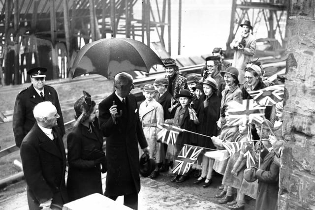 There's plenty of smiles and warmth for Princess Elizabeth as she leaves the Deptford shipyard of Sir James Laing & Sons.