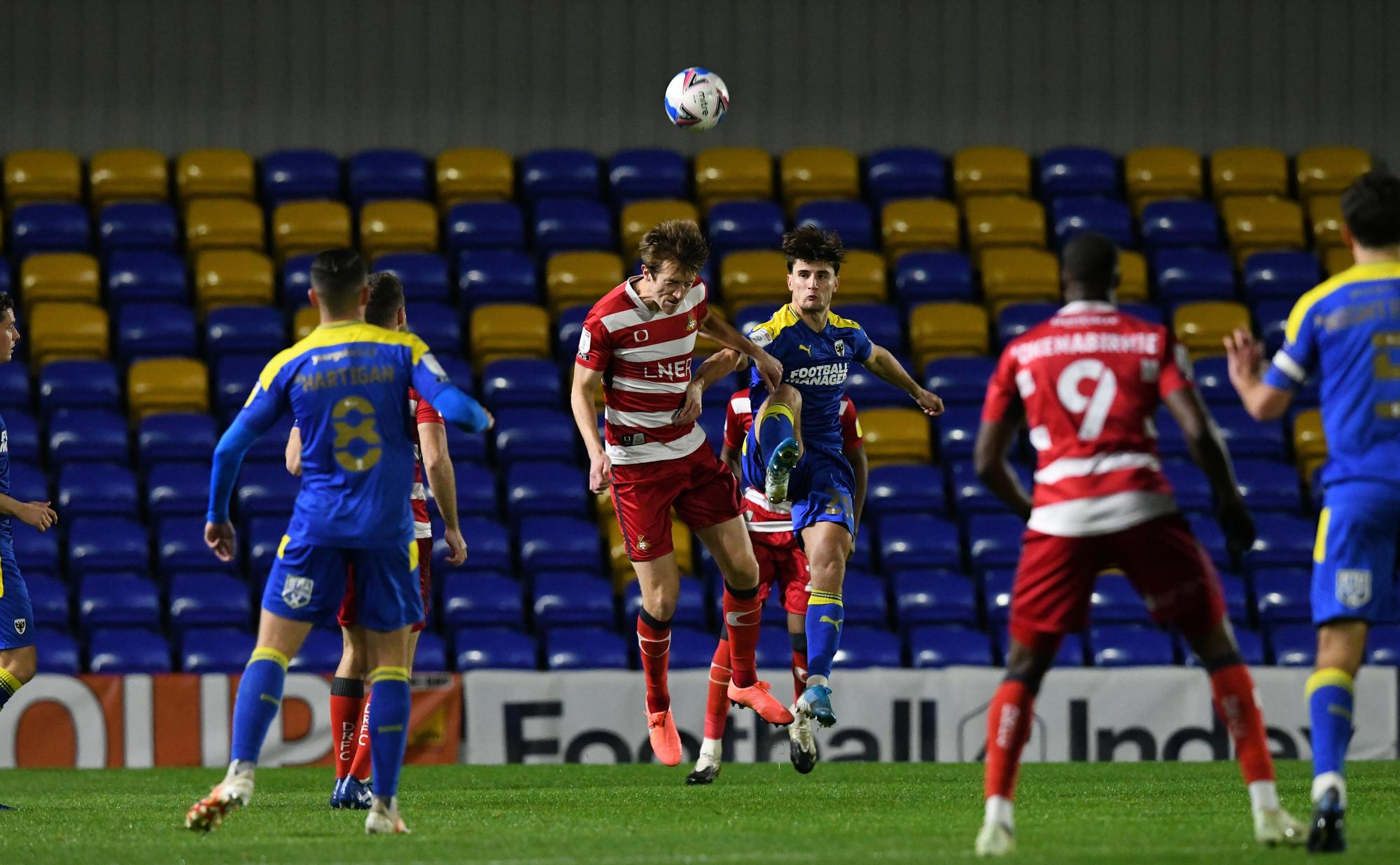 Tom Anderson rises to head the ball.