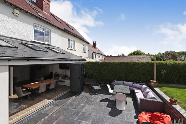 Bi-fold doors open from the dining area to the patio, which looks like a lovely suntrap.