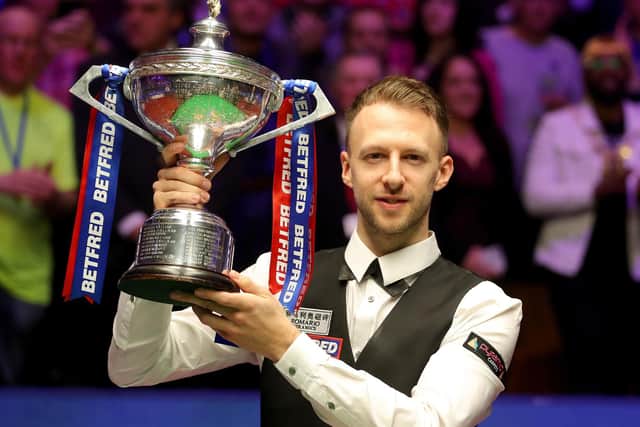 Judd Trump celebrates with the trophy after winning the 2019 Betfred World Championship at The Crucible, Sheffield. Photo: Richard Sellers/PA Wire.