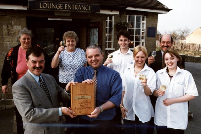 Whitbread Sherwood Inn operations manager, Phil Bromley (front left) is seen presenting licensee Frank Ridge and his team of staff from The Sportsman on Oldfield Road, Stannington, with the Team Hospitality Award, March 21, 1997