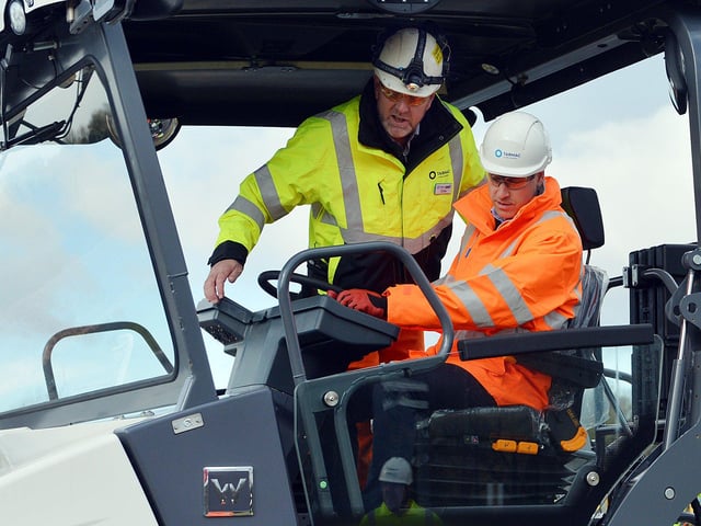 The Duke of Cambridge visits Tarmac's national skills and safety park to officially open the centre. The Duke of Cambridge being shown how to use a paver machine by Chris Hill.