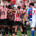 Sheffield United's players mob Ollie Norwood after his stunning free-kick against Blackburn Rovers: Simon Bellis / Sportimage
