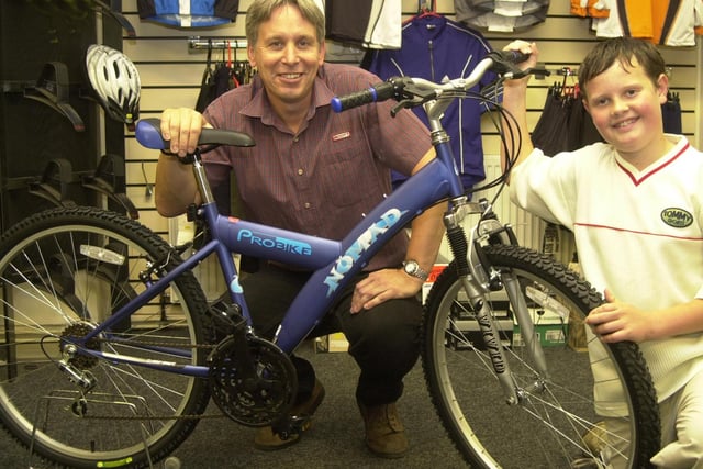 Birley Cycle Shop owner Dave Shelton pictured with Thomas Biggin after presenting him with a new bike to replace the one that he had stolen