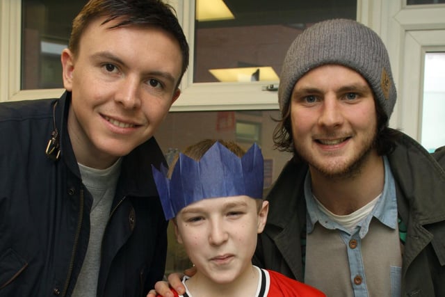 Tyler Dixon, aged 13, is pictured with Town players Gregor Robertson and Tommy Lee.