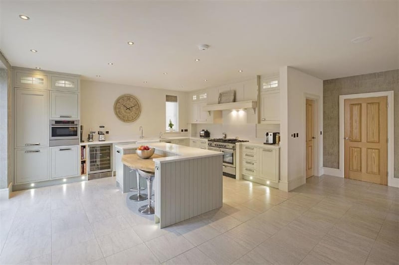 A main feature of this stunning home is its spacious living kitchen that offers dining space, sitting areas, including one with a multi-burning stove, and a fitted breakfast kitchen.