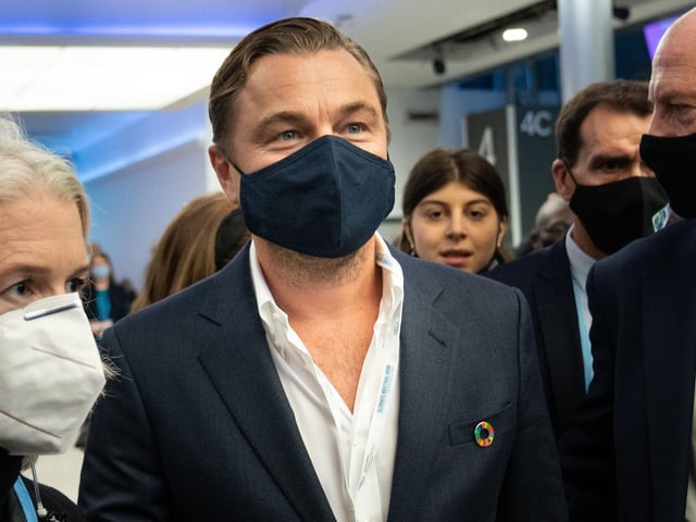 DiCaprio wore a blue suit, featuring a colourful lapel pin.