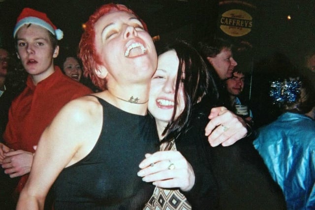 Two friends hugs and smile while on a night out