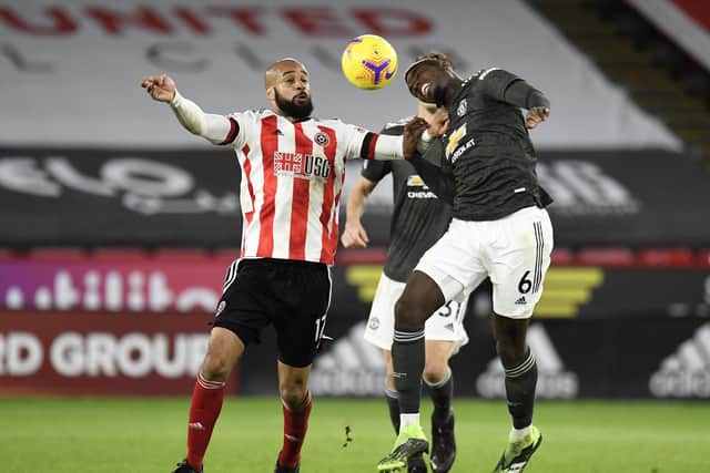 David McGoldrick of Sheffield United battles for possession with Paul Pogba of Manchester United during the Premier League match between Sheffield United and Manchester United at Bramall Lane .  (Photo by Peter Powell - Pool/Getty Images)