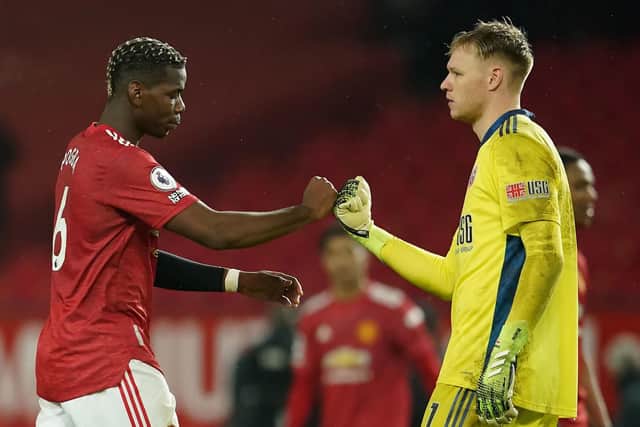 Manchester United's Paul Pogba bumps fists with Sheffield United goalkeeper Aaron Ramsdale: Dave Thompson/PA Wire.