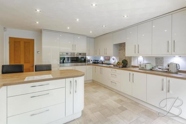 A high-specification kitchen comes complete with a range of gloss wall and base units and integrated appliances,. It is complemented perfectly by modern fixtures and fittings.