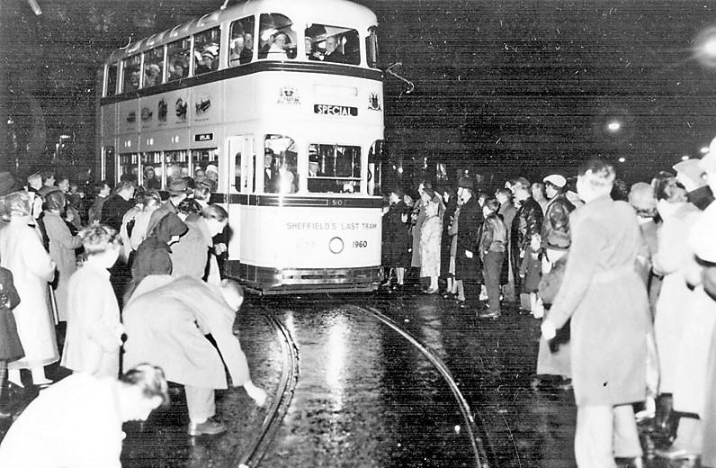 Coins being placed on the tram tracks to be flattened as the last tram procession passes through the city centre during Last Tram Week, 1960 (S16664)