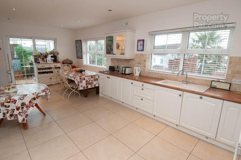 Spacious kitchen with attached conservatory.