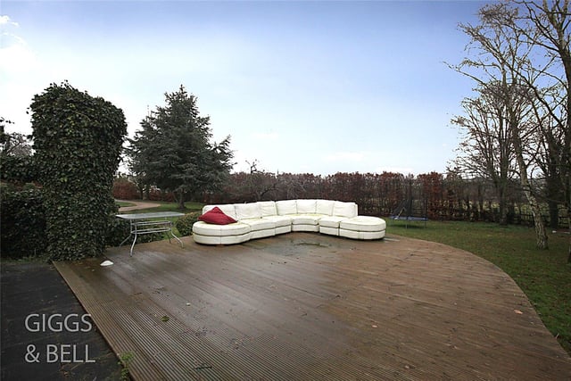 The spacious wooden decking provides a relaxing space to entertain guests in the summer and can be found in the front garden, near the sweeping gravel driveway, and overlooking the lawn.