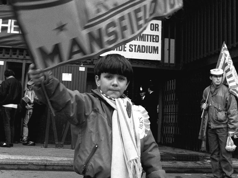 This young fan waves his flag for the mighty Stags outside the ground.