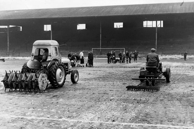 Snow is cleared from the pitch in February 1963.