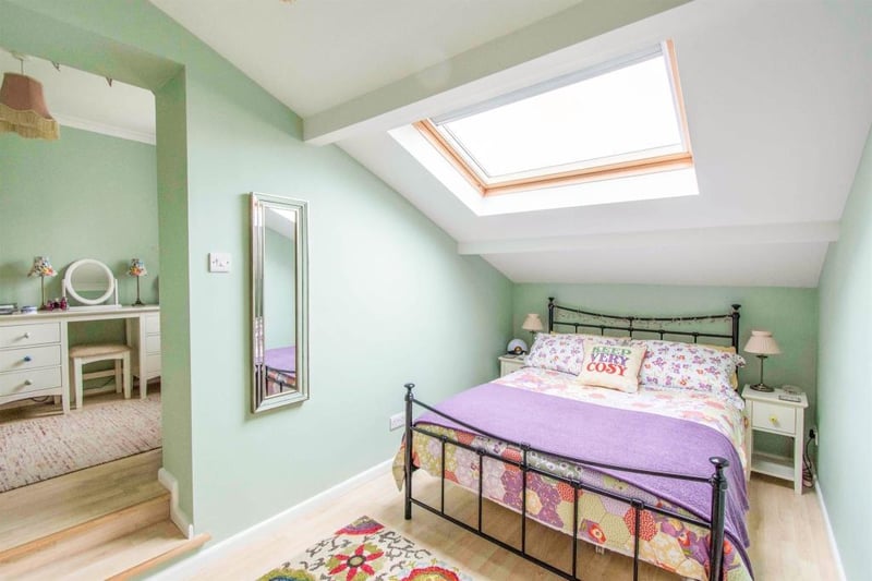 Master bedroom -  a double room with a rear facing double glazed skylight window, a TV point, laminate flooring and a central heating radiator. A door gives access to the ensuite and dressing room.