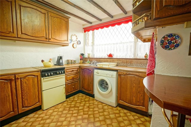 The kitchen may be on the small side, but it does have a breakfast bar and a stainless steel sink with a mixer tap.