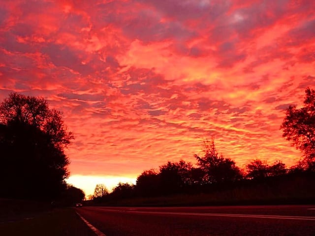 A dramatic blood-red sky gleamed off the road at Polkemmet this morning.