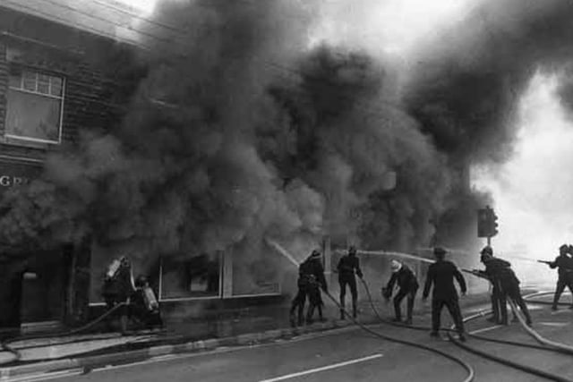 Firefighters train their hoses on a blaze at William Monks builders merchants on Queens Road, Sheffield, on October 10, 1972